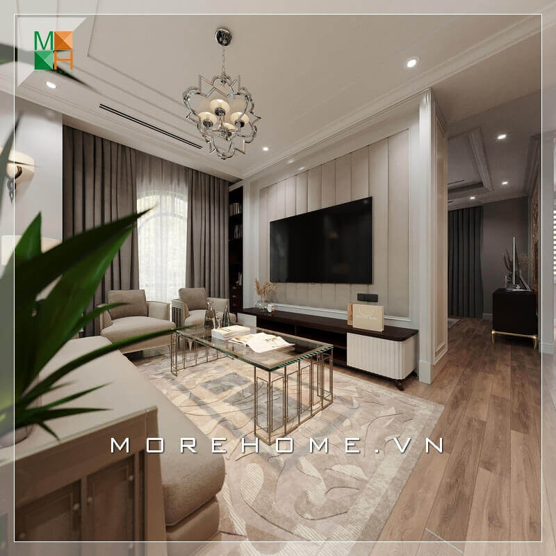 Trong thiết kế nội thất phòng khách chung cư tân cổ điển kết hợp hiện đại, có rất nhiều người lựa chọn ghế sofa làm điểm nhấn trang trí. Ghế sofa vải đem lại sự hài hòa, trang nhã cũng như giá thành hợp lý. Bên cạnh đó, kệ TV cũng là một điểm đáng lưu ý khi trang trí phòng khách. Kệ TV thường được làm bằng gỗ công nghiệp cao cấp An Cường đảm bảo tính bền bỉ và đẹp. Thiết kế mảng tường treo của TV rất ấn tượng với những cái phào nổi đúng chất phong cách tân cổ điển. Thiết kế khách chung cư